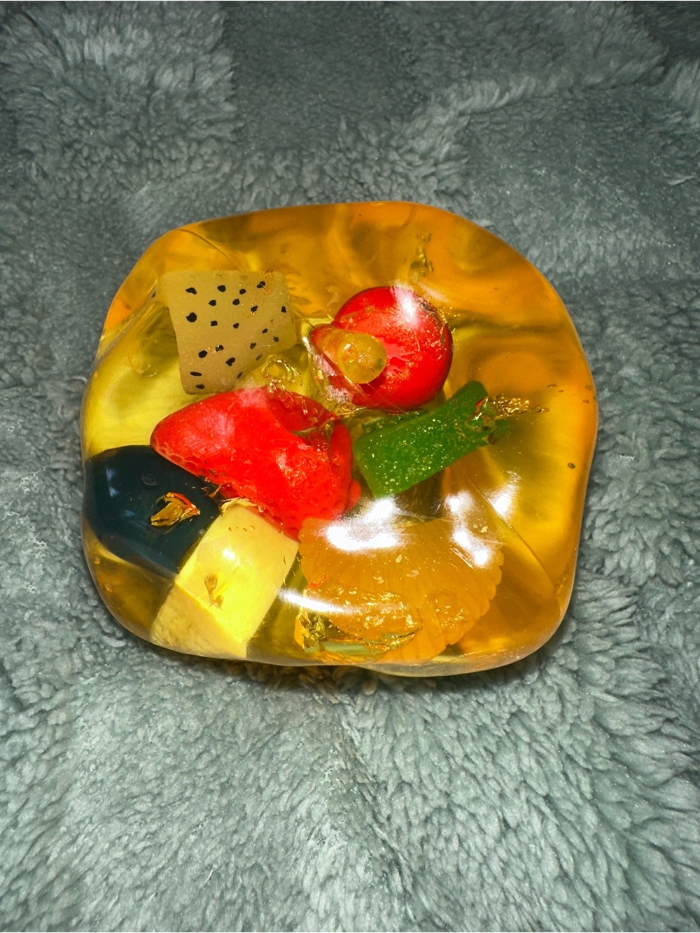 Big coconut oil squishy with embedded fruit charms.